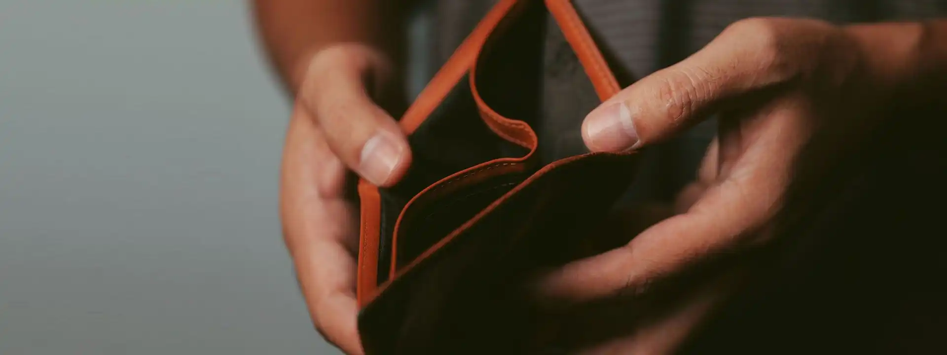 close-up of man's hands opening an empty wallet